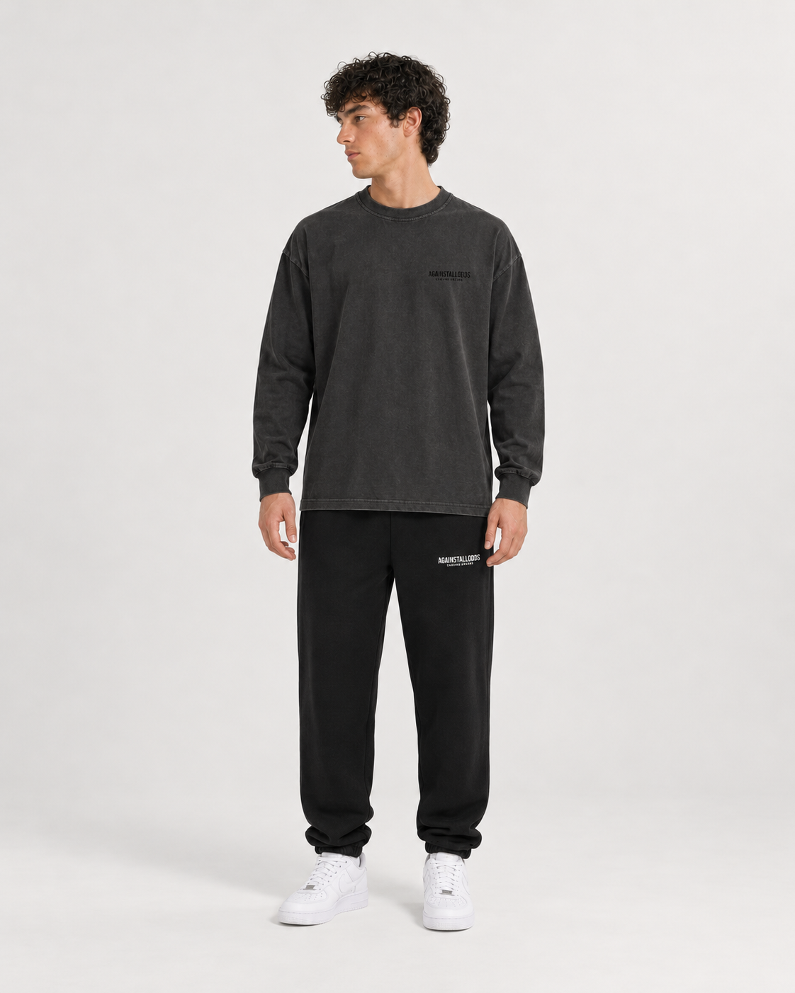 AI-generated styling illustration: Dreamers Distressed Luxury Long Sleeve Tee with AAO black sweatpants, front view.