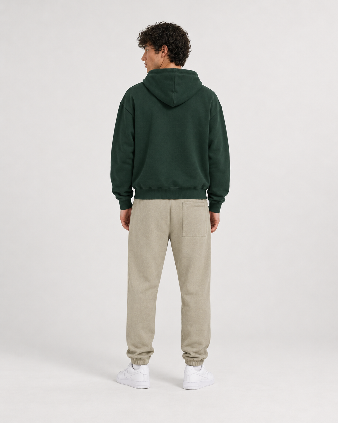 AI-generated styling illustration: College Green Luxury Hoodie with AAO Sandune sweatpants, back view.