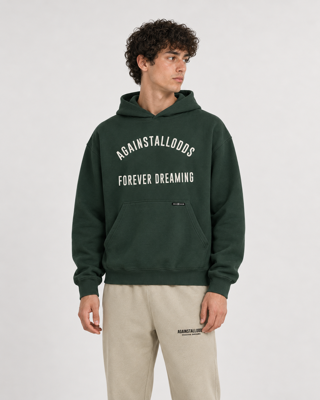AI-generated styling illustration: College Green Luxury Hoodie with AAO Sandune sweatpants, closer view.