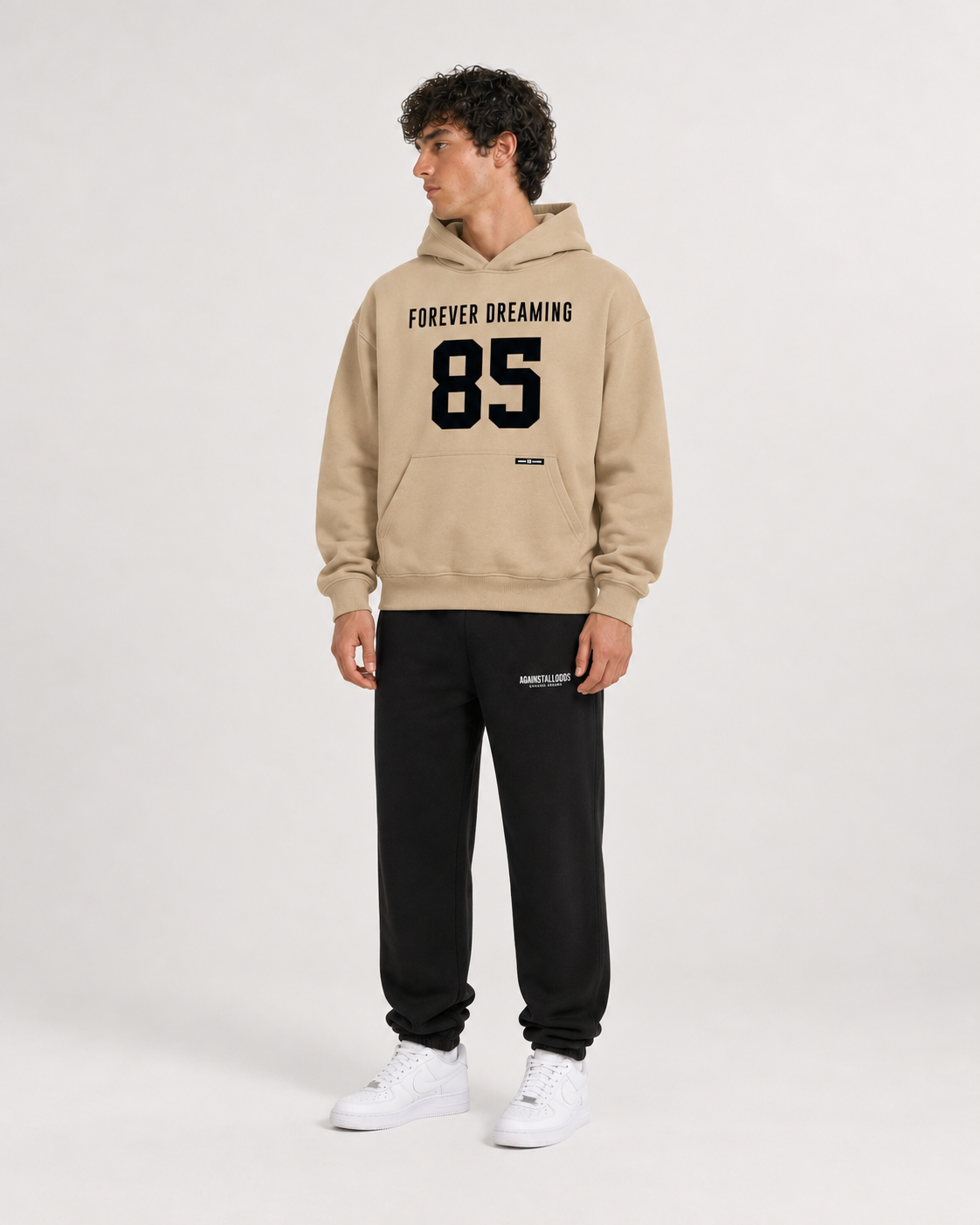 AI-generated styling illustration: 85 Coffee Luxury Hoodie with AAO black sweatpants, front view.