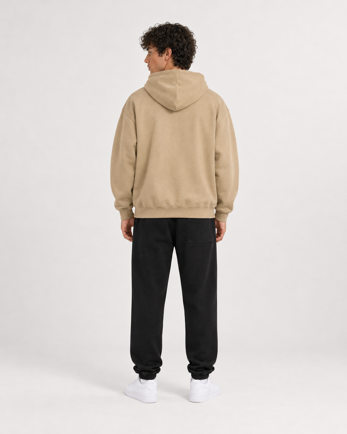 AI-generated styling illustration: 85 Coffee Luxury Hoodie with AAO black sweatpants, back view.