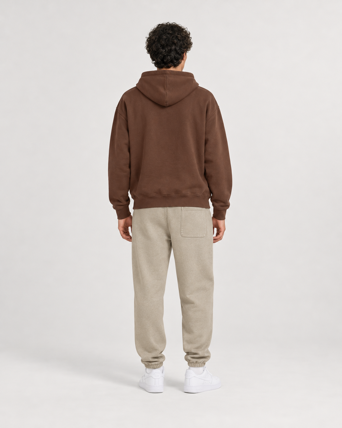 AI-generated styling illustration: AAO Forever Dreaming Brown Luxury Hoodie with AAO Sandune sweatpants, back view.
