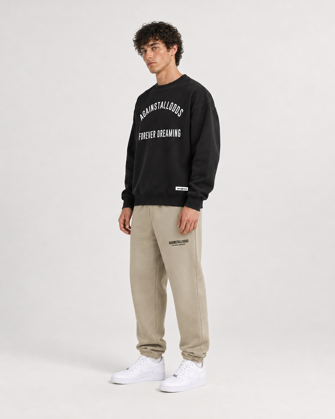 AI-generated styling illustration: AAO College Black Luxury Sweatshirt with AAO Sandune sweatpants, side view.