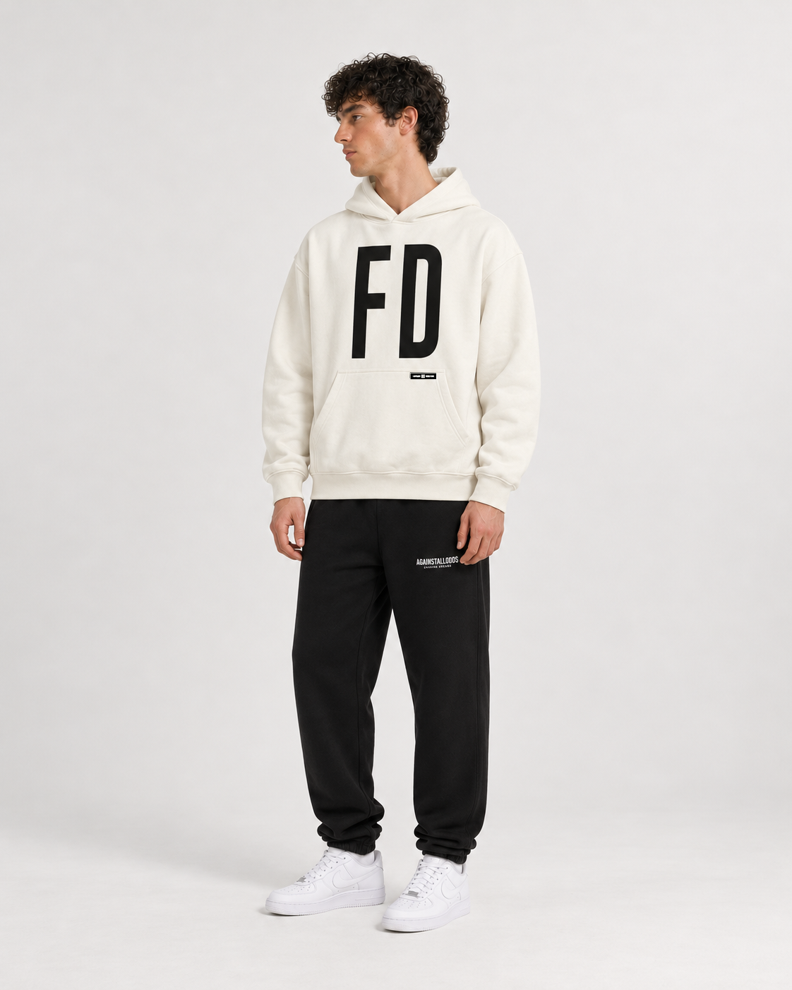 AI-generated styling illustration: AAO FD Ivory Luxury Hoodie with AAO black sweatpants, front view.