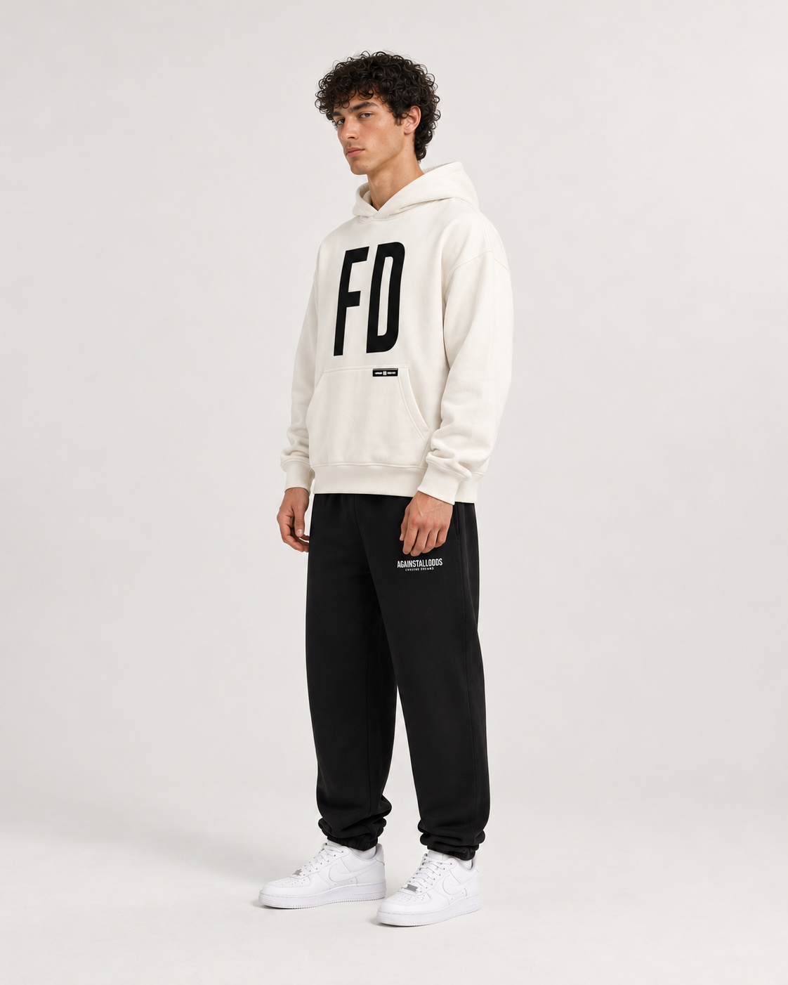 AI-generated styling illustration: AAO FD Ivory Luxury Hoodie with AAO black sweatpants, side view.