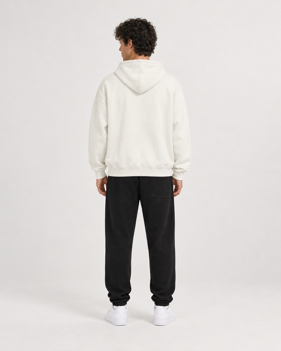 AI-generated styling illustration: AAO Forever Dreaming Ivory Luxury Hoodie with AAO black sweatpants, back view.