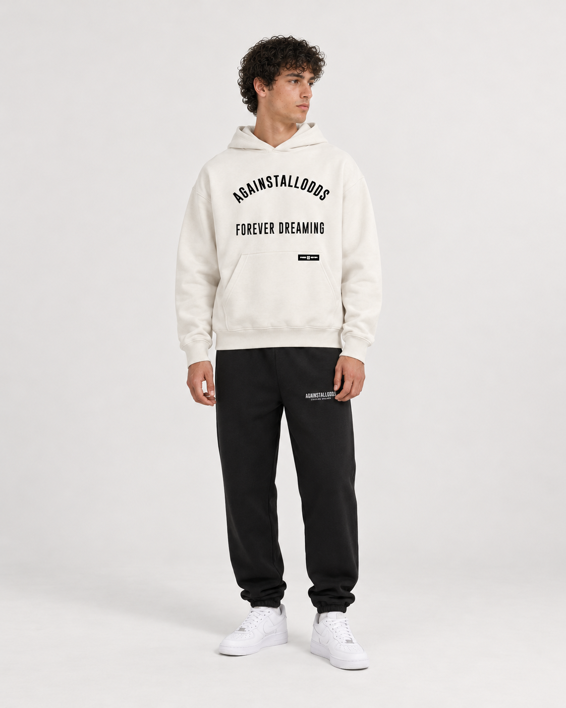 AI-generated styling illustration: AAO College Ivory Luxury Hoodie with AAO black sweatpants, front view.