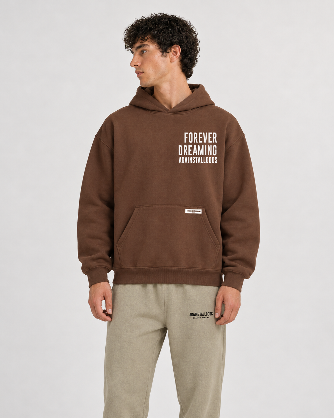 AI-generated styling illustration: AAO Forever Dreaming Brown Luxury Hoodie with AAO Sandune sweatpants, closer view.