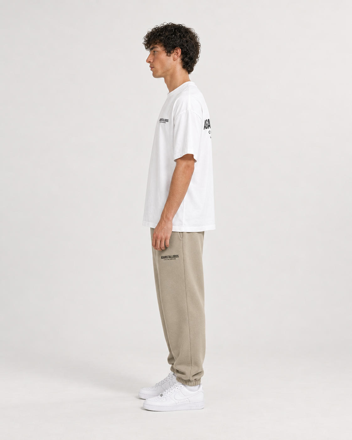 AI-generated styling illustration: Dreamers white luxury boxy tee with AAO Sandune sweatpants, three quarter view.