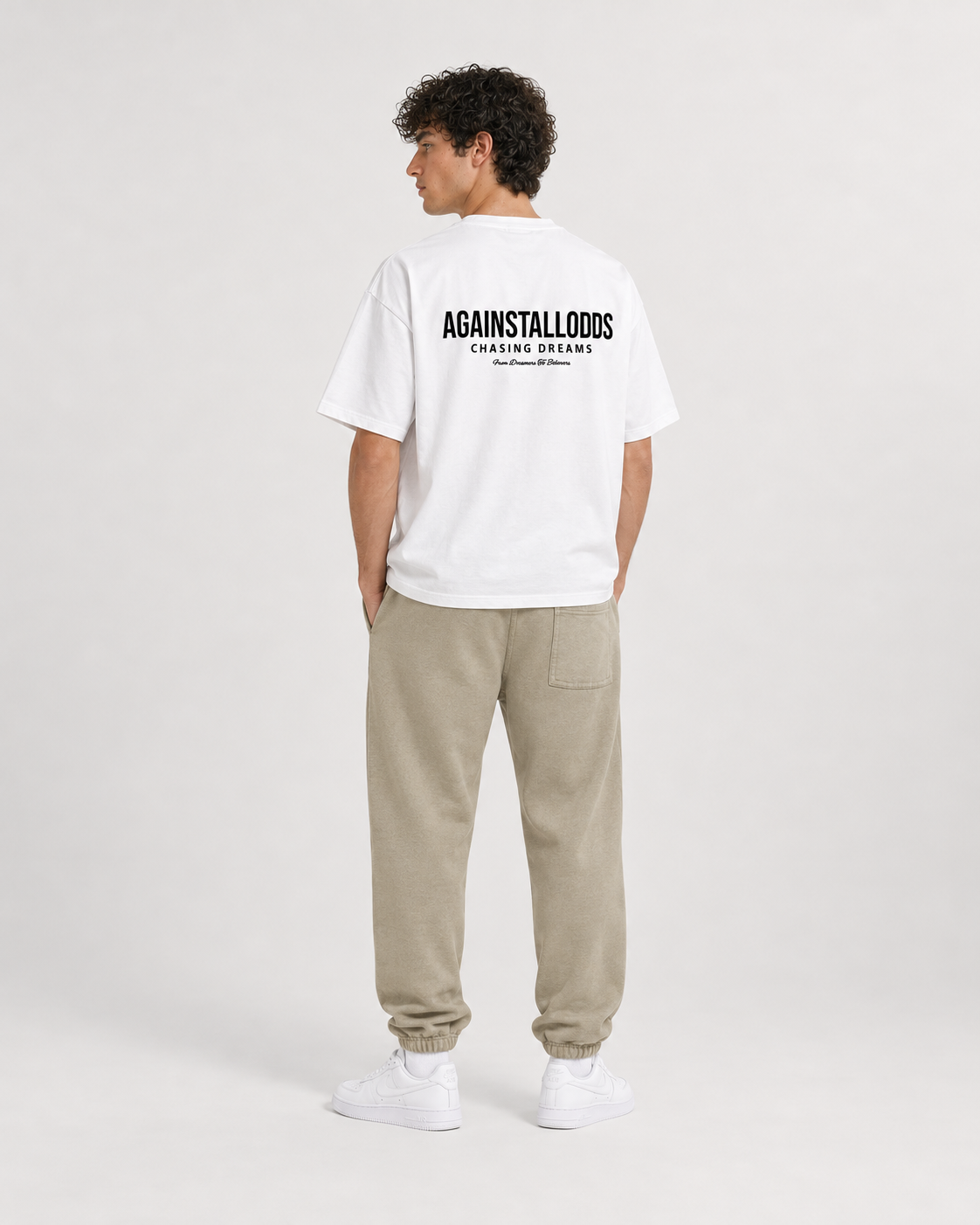 AI-generated styling illustration: Dreamers white luxury boxy tee with AAO Sandune sweatpants, back view.