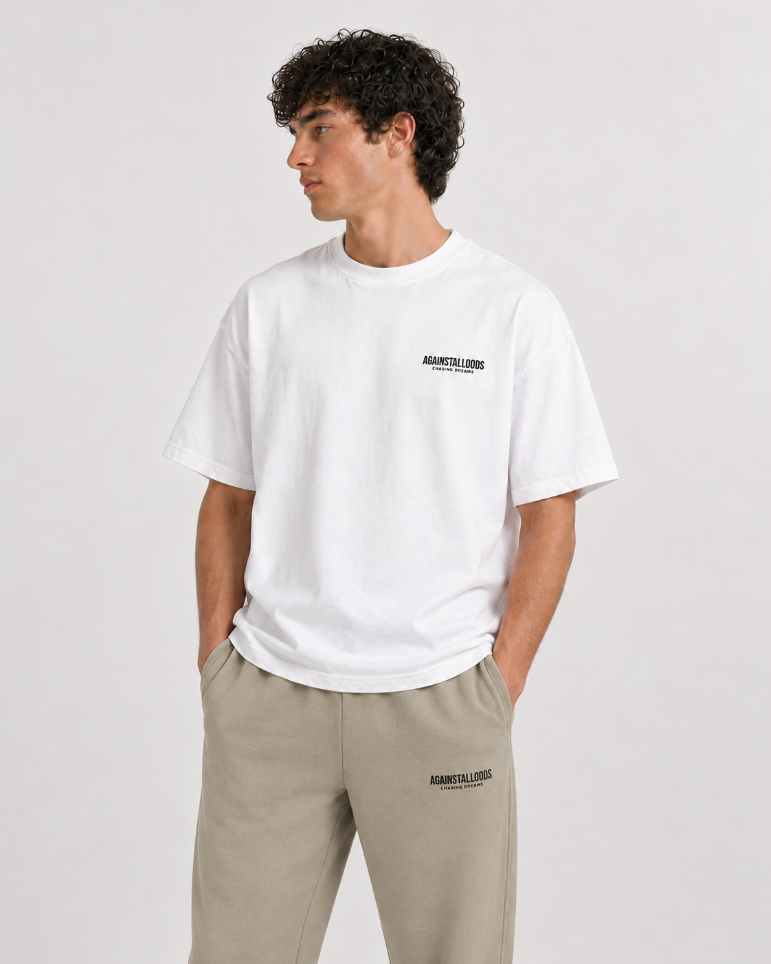 AI-generated styling illustration: Dreamers white luxury boxy tee with AAO Sandune sweatpants, closer view.