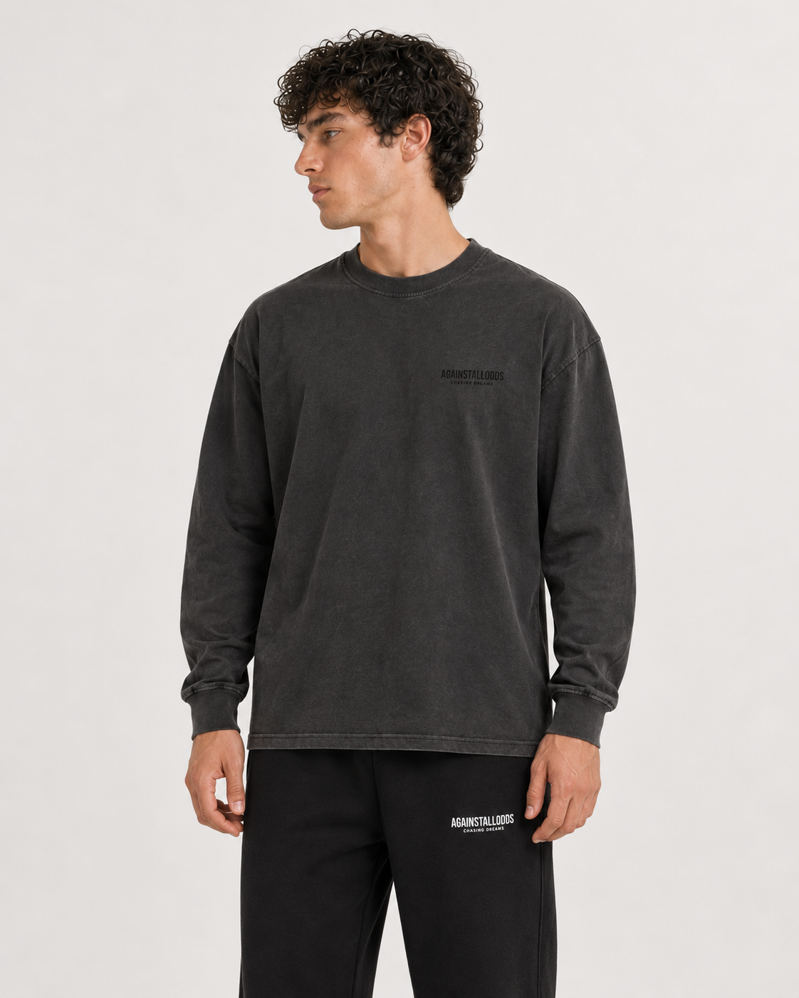AI-generated styling illustration: Dreamers Distressed Luxury Long Sleeve Tee with AAO black sweatpants, closer view.