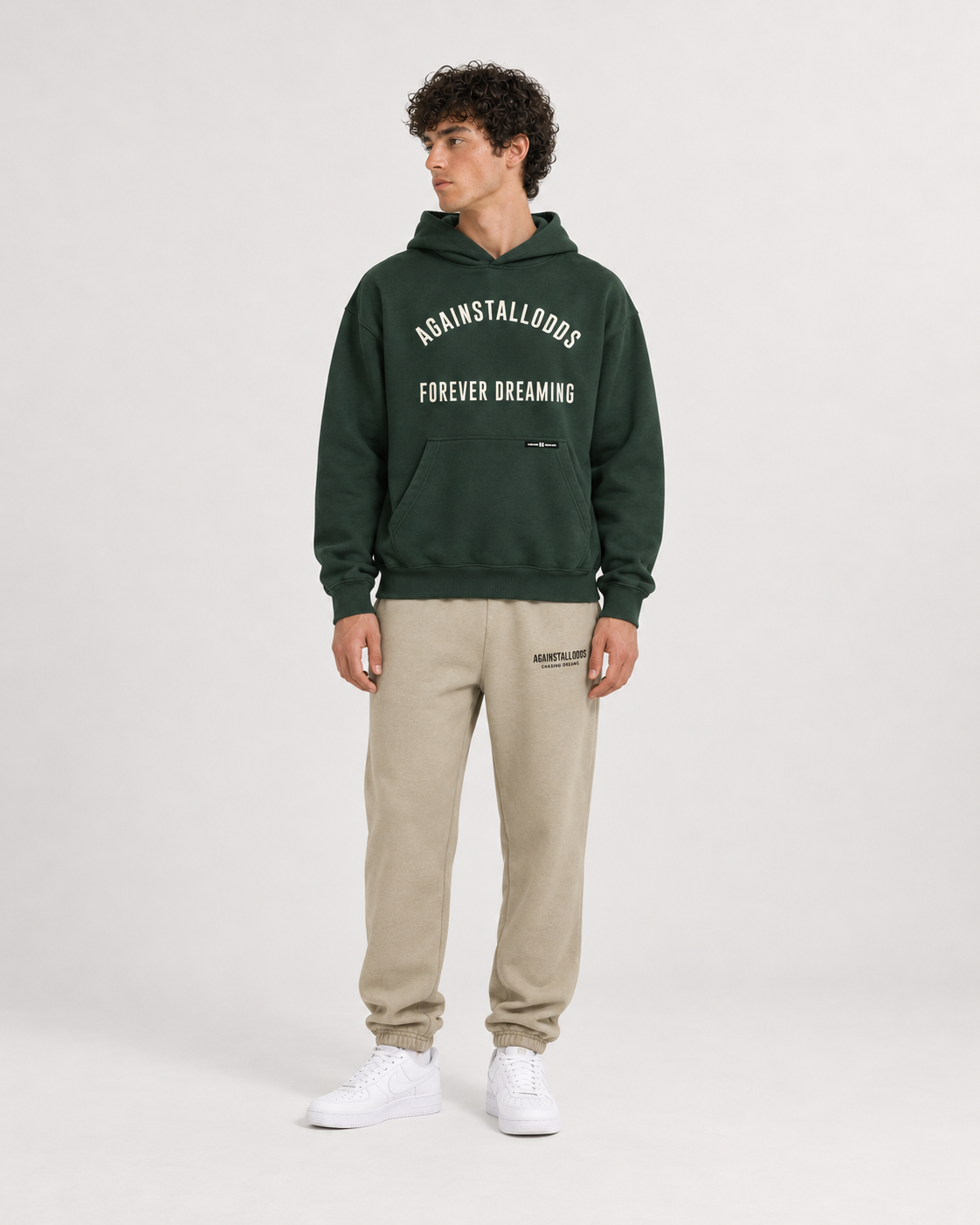 AI-generated styling illustration: College Green Luxury Hoodie with AAO Sandune sweatpants, front view.