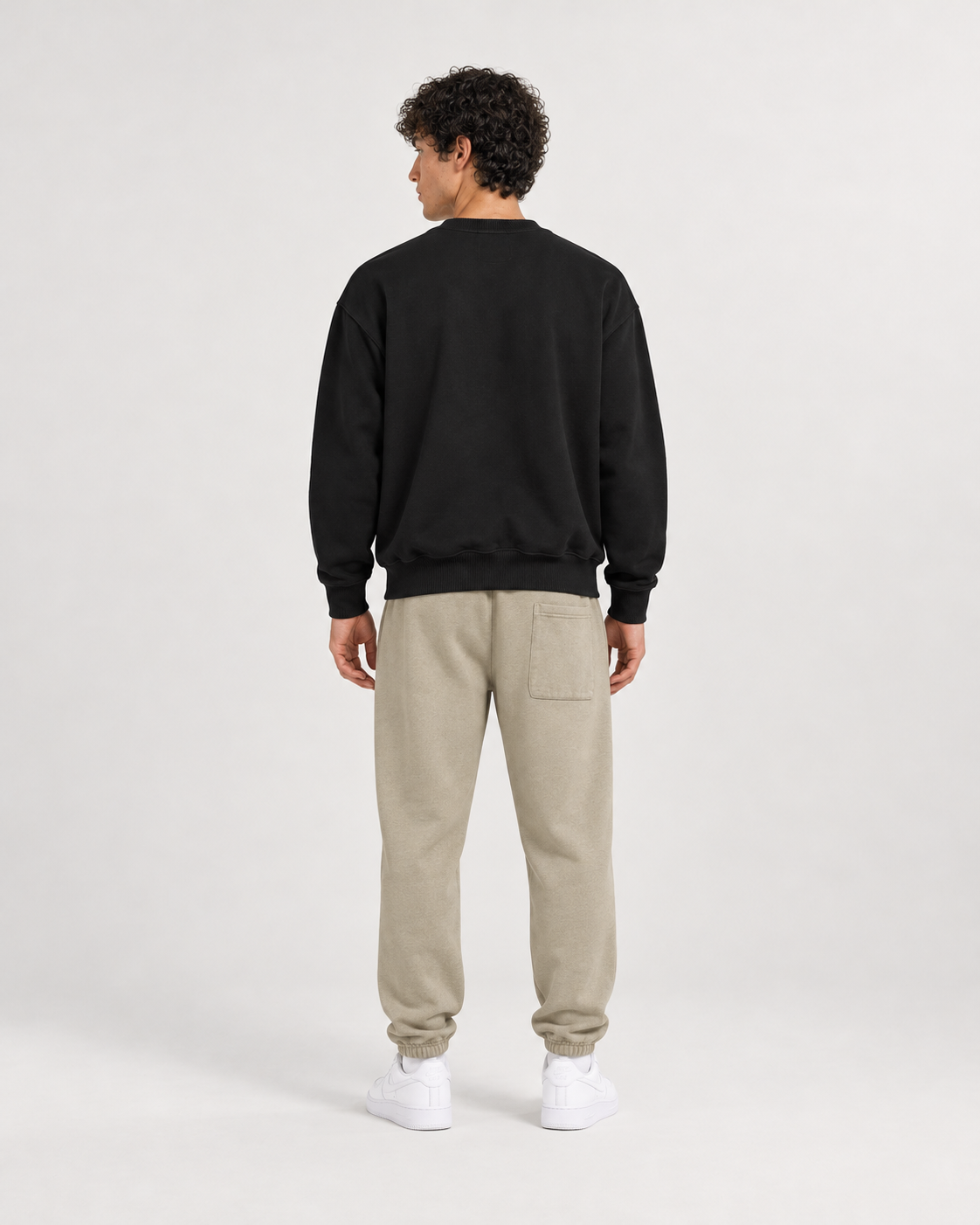 AI-generated styling illustration: AAO College Black Luxury Sweatshirt with AAO Sandune sweatpants, back view.