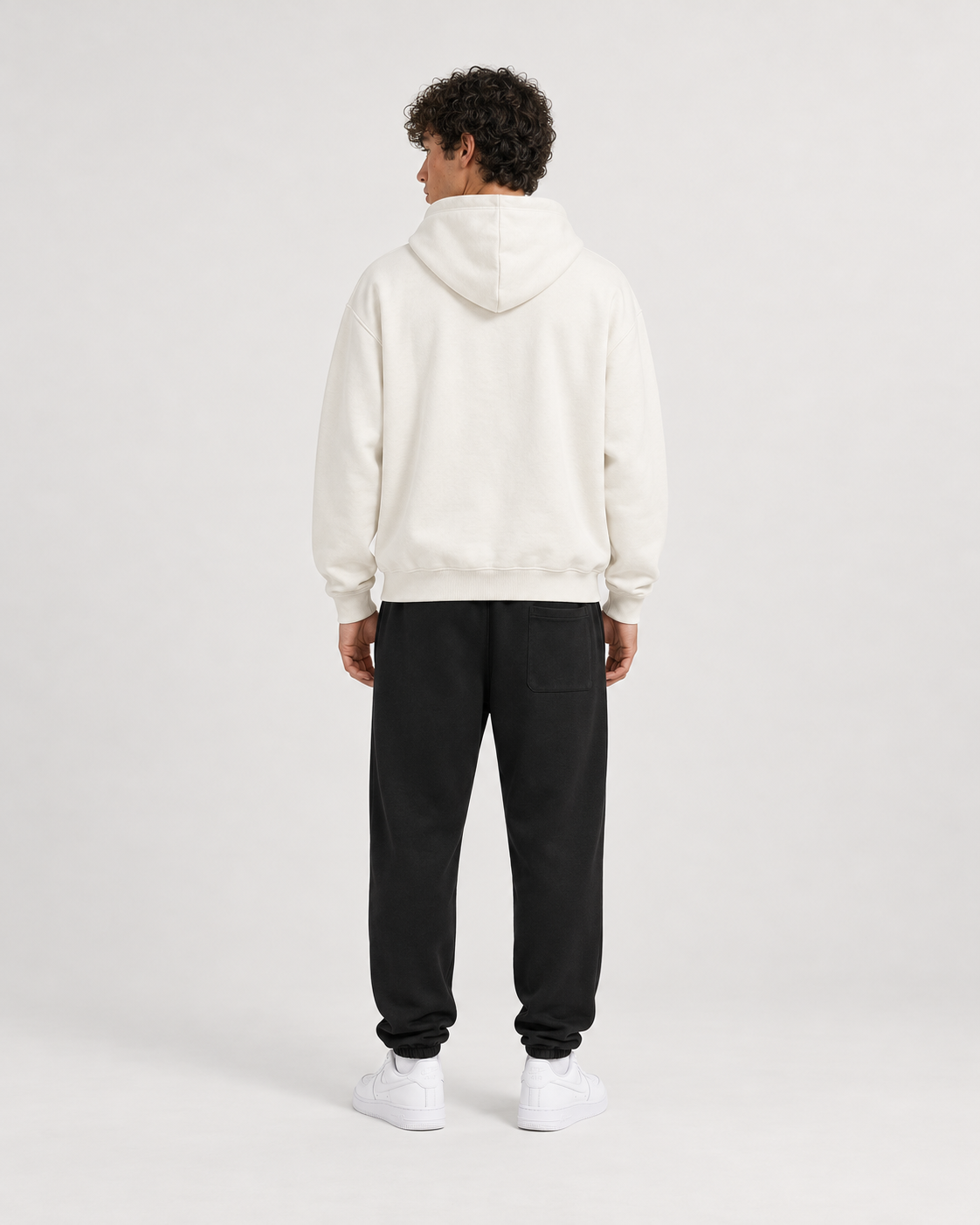 AI-generated styling illustration: AAO FD Ivory Luxury Hoodie with AAO black sweatpants, back view.