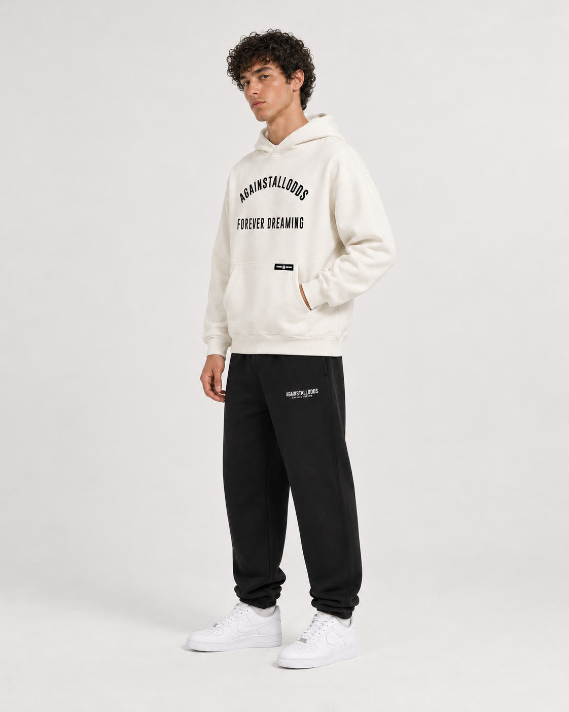 AI-generated styling illustration: AAO College Ivory Luxury Hoodie with AAO black sweatpants, side view.