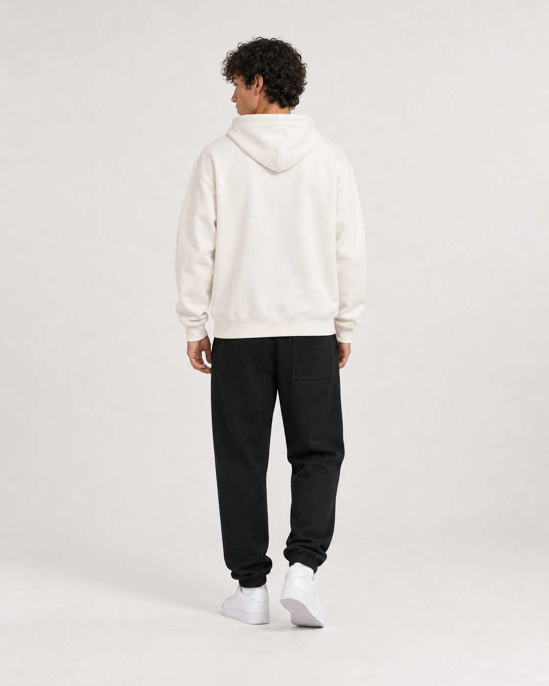 AI-generated styling illustration: AAO College Ivory Luxury Hoodie with AAO black sweatpants, back view.