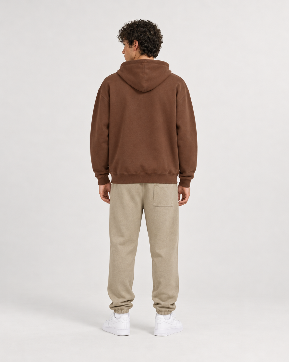AI-generated styling illustration: AAO Forever Dreaming Brown Luxury Hoodie with AAO Sandune sweatpants, back view.