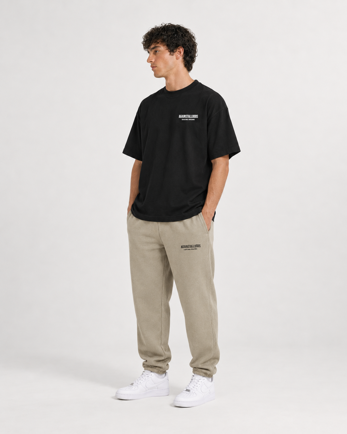 AI-generated styling illustration: Dreamers black luxury boxy tee with AAO Sandune sweatpants, front view.