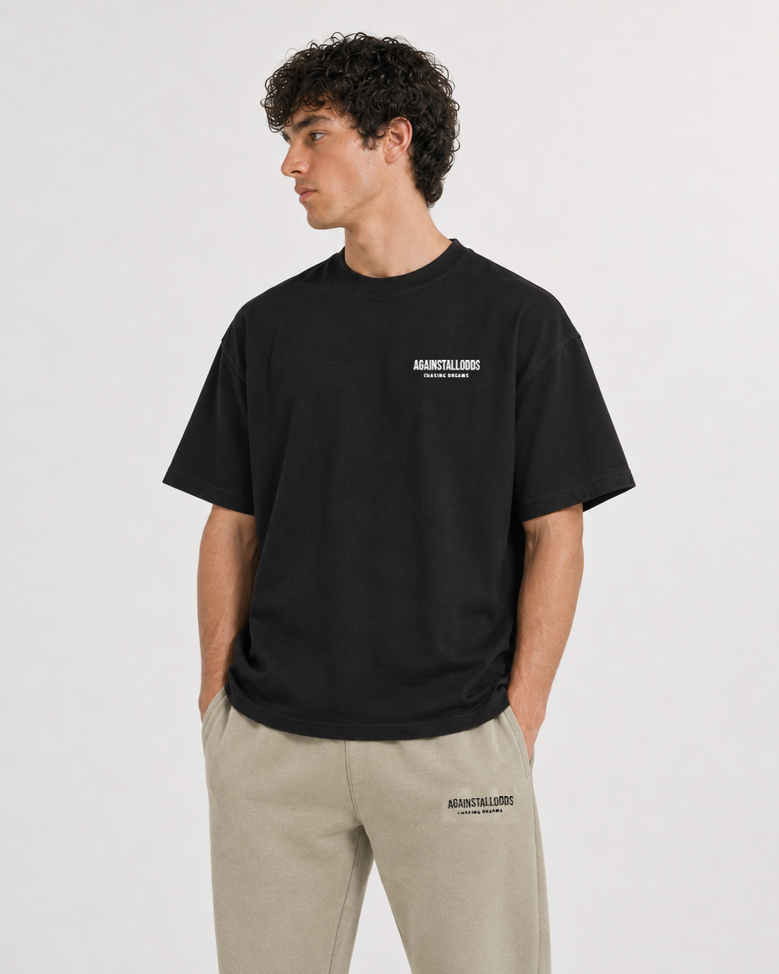 AI-generated styling illustration: Dreamers black luxury boxy tee with AAO Sandune sweatpants, closer view.