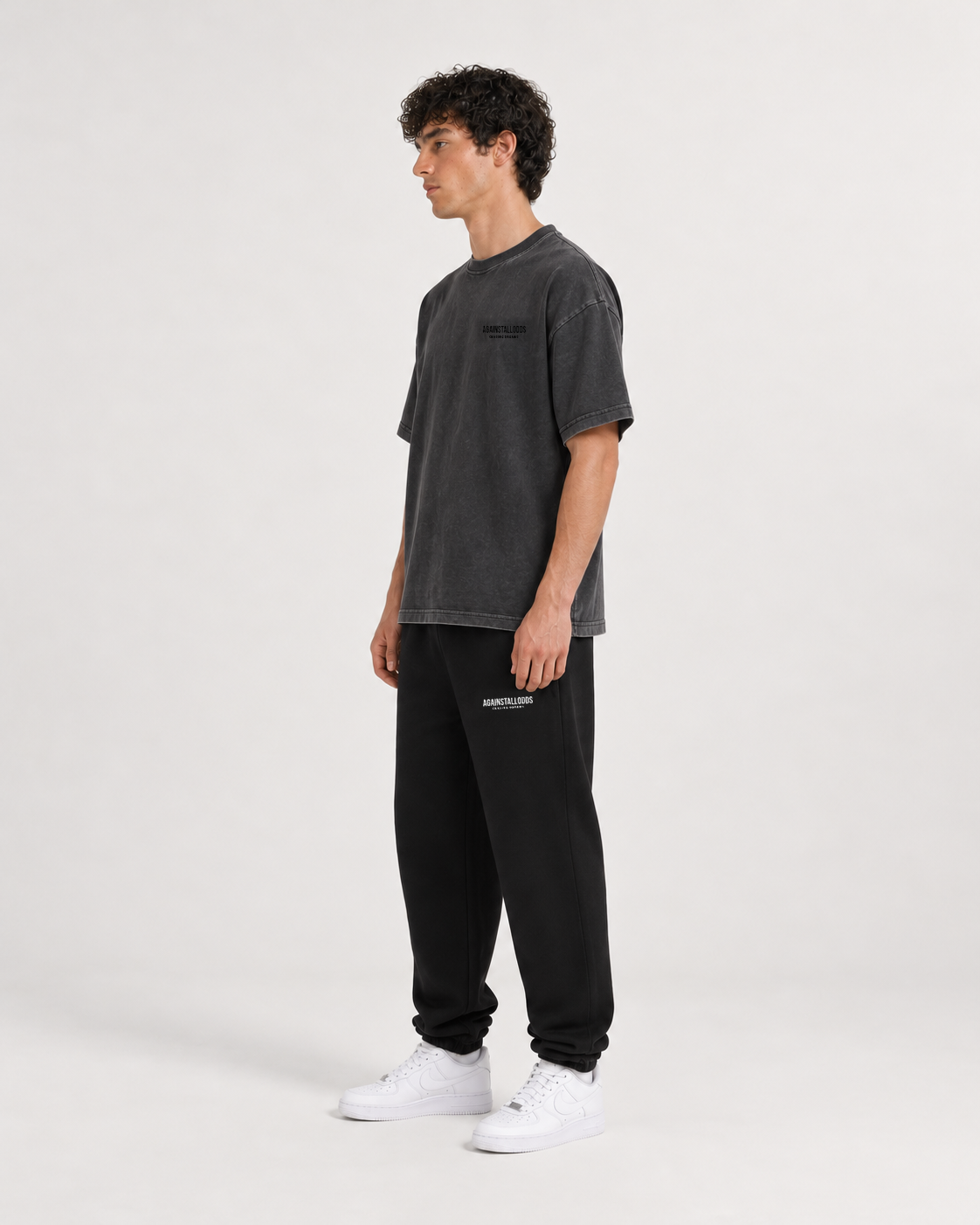 AI-generated styling illustration: Dreamers distressed luxury boxy tee with AAO black sweatpants, three quarter view.
