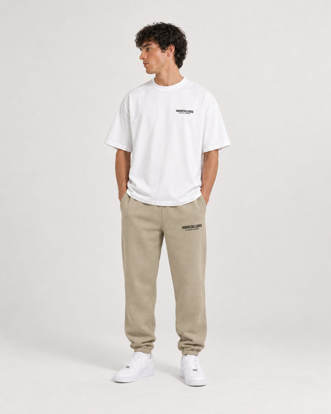 AI-generated styling illustration: Dreamers white luxury boxy tee with AAO Sandune sweatpants, front view.
